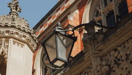 Looking up at Cambridge architecture with blue sky behind