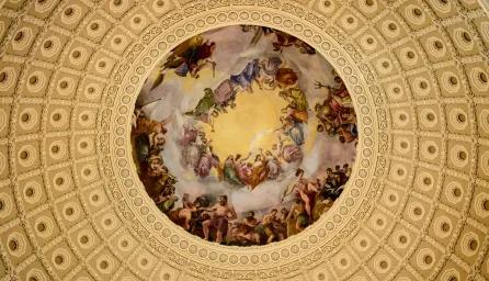 Figurative painting in a circular frame of a domed ceiling, viewed from below. 