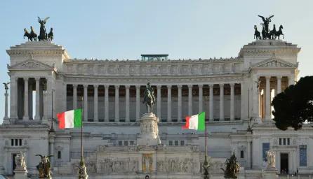 Italian government building with Italian flags displayed outside its entrance