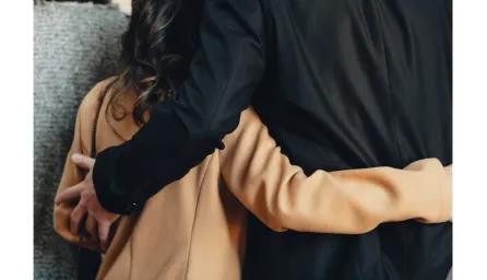 Couple with arms around each other in support
