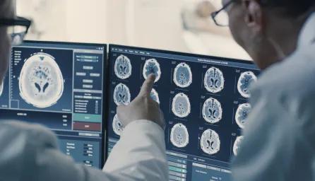 People in white coats studying scans of body