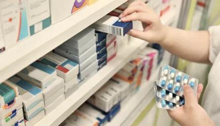 Person checking inventory of pharmacy products