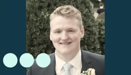 man with light blonde hair, in suit smiling for photo 