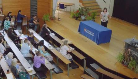 People in lecture theatre listening to a talk