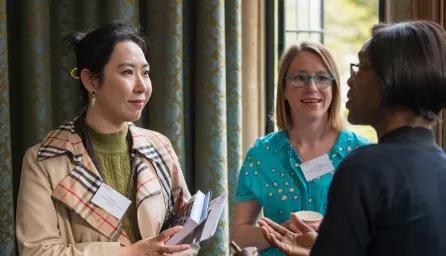 Three women engaging in conversation.