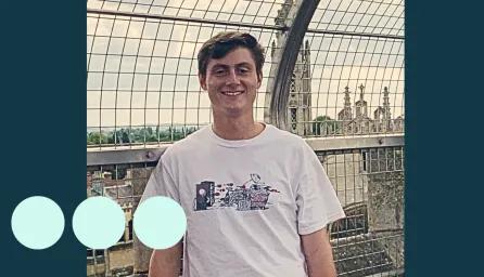 Young man with brown hair smiling for photo