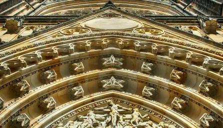 A low-angle view of a gold-toned architectural building