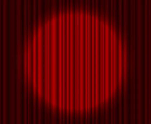 Spotlight shining on red stage curtains