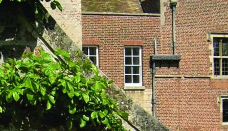A close up photo of Madingley hall roof, building and windows.  