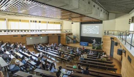 Tutor speaking to a lecture theatre full of students