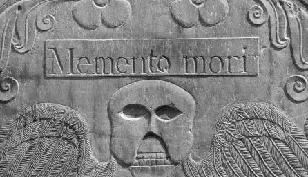 Detail from an 18th century headstone in a cemetery in Concord, Massachusetts. The winged death's head design was common in 18th century New England. "Memento mori" is Latin phrase, meaning, "Remember you will die."