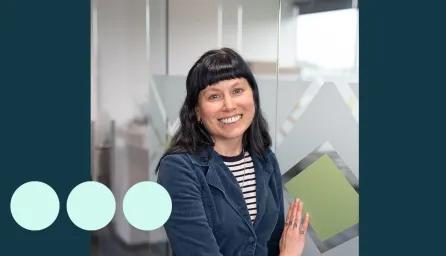 Women smiling with black hair and blue jacket