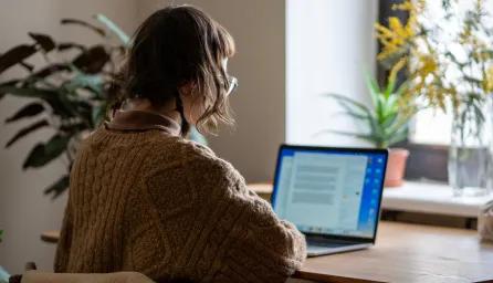woman sat at laptop in home office