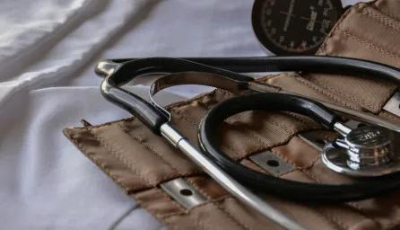Close-up of a historical doctor's kit, a pouch including a stethoscope and other medical instruments. 
