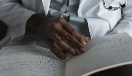 Close-Up Shot of a Doctor Reading His Notes