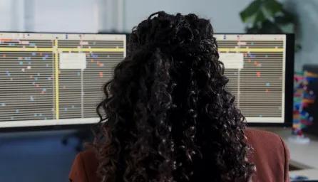 Back of head looking at genomic sequencing on a computer 
