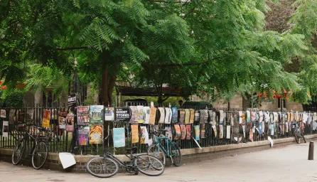 Wrought iron fence covered in posters