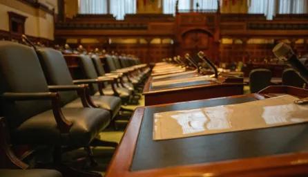 Government chamber with desk rows and microphones