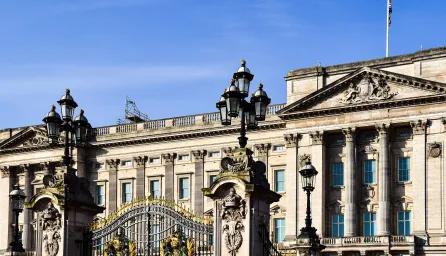 Exterior view of Buckingham Palace in London showcasing its historic architecture and ornate gate