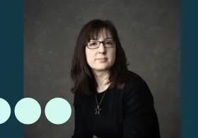 Headshot of woman with dark hair and glasses