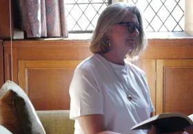 Person sat in library reading open book