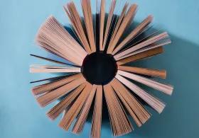 Aerial perspective of a group of paperback books arranged in a circle, their pages fanning out.