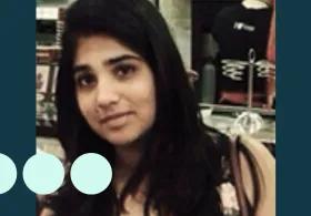 Image of woman with long black hair looking directly into camera