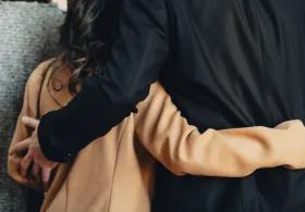 Couple with arms around each other in support