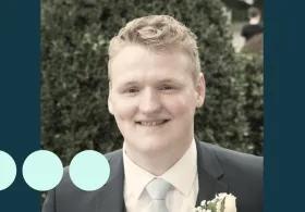 man with light blonde hair, in suit smiling for photo 