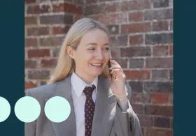 Blonde woman wearing suit, walking and talking on a mobile phone