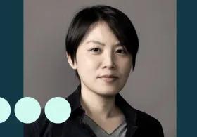 Asian woman with short hair looking at camera