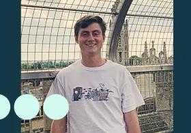 Young man with brown hair smiling for photo