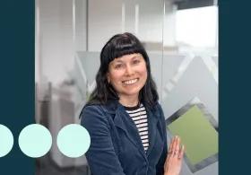 Women smiling with black hair and blue jacket