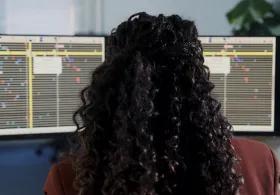 Back of head looking at genomic sequencing on a computer 