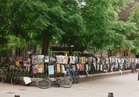 Wrought iron fence covered in posters