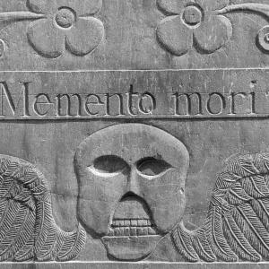 Detail from an 18th century headstone in a cemetery in Concord, Massachusetts. The winged death's head design was common in 18th century New England. "Memento mori" is Latin phrase, meaning, "Remember you will die."