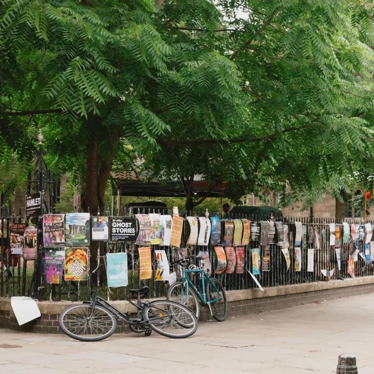 Wrought iron fence covered in posters