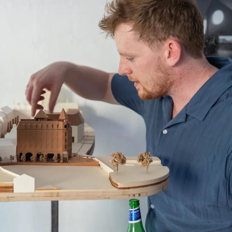 Students and guest looking at building models at the architecture exhibition bition 