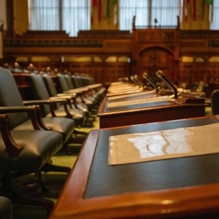 Government chamber with desk rows and microphones