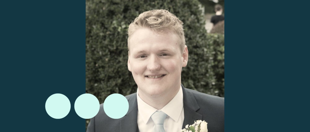 man with light blonde hair, in suit smiling for photo 