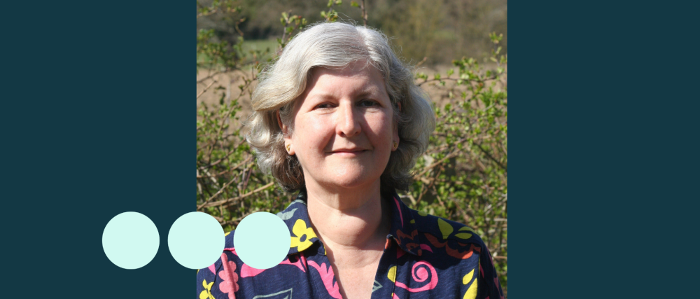 Older woman with silver short wavy hair 