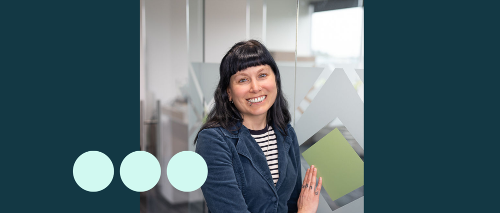 Women smiling with black hair and blue jacket